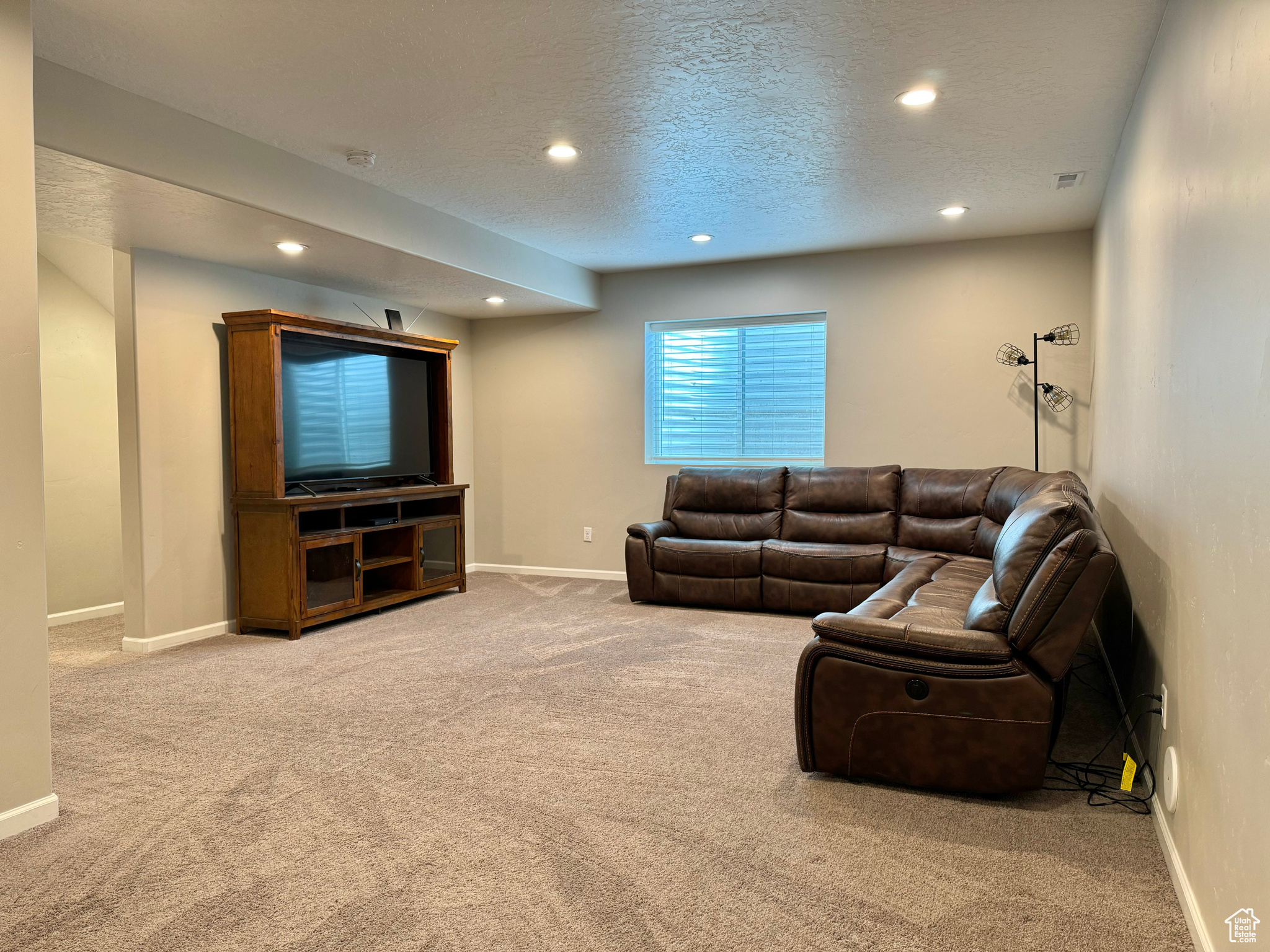 Basement Family Room with a textured ceiling and carpet flooring