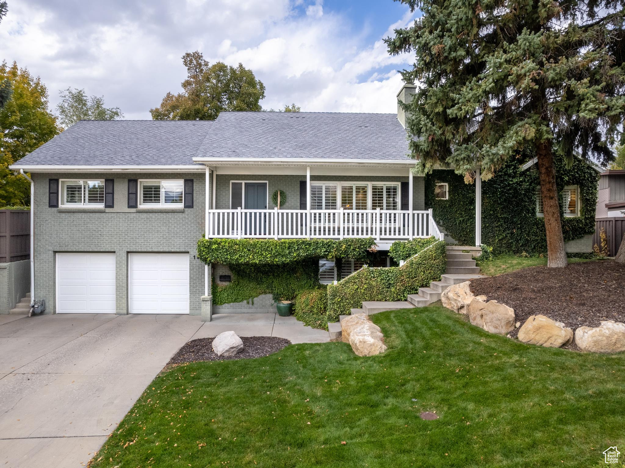 View of front of house featuring a front yard and a garage