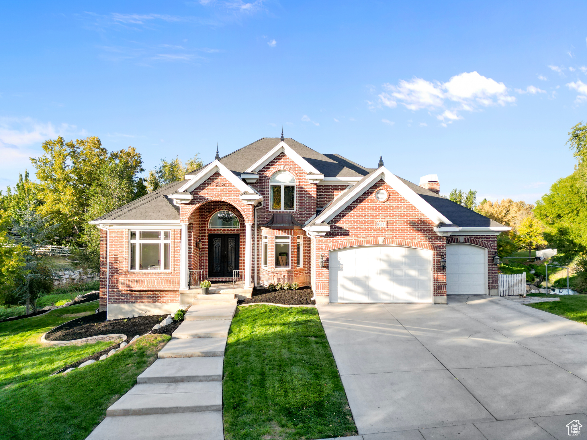 View of front of house with a front lawn and a garage