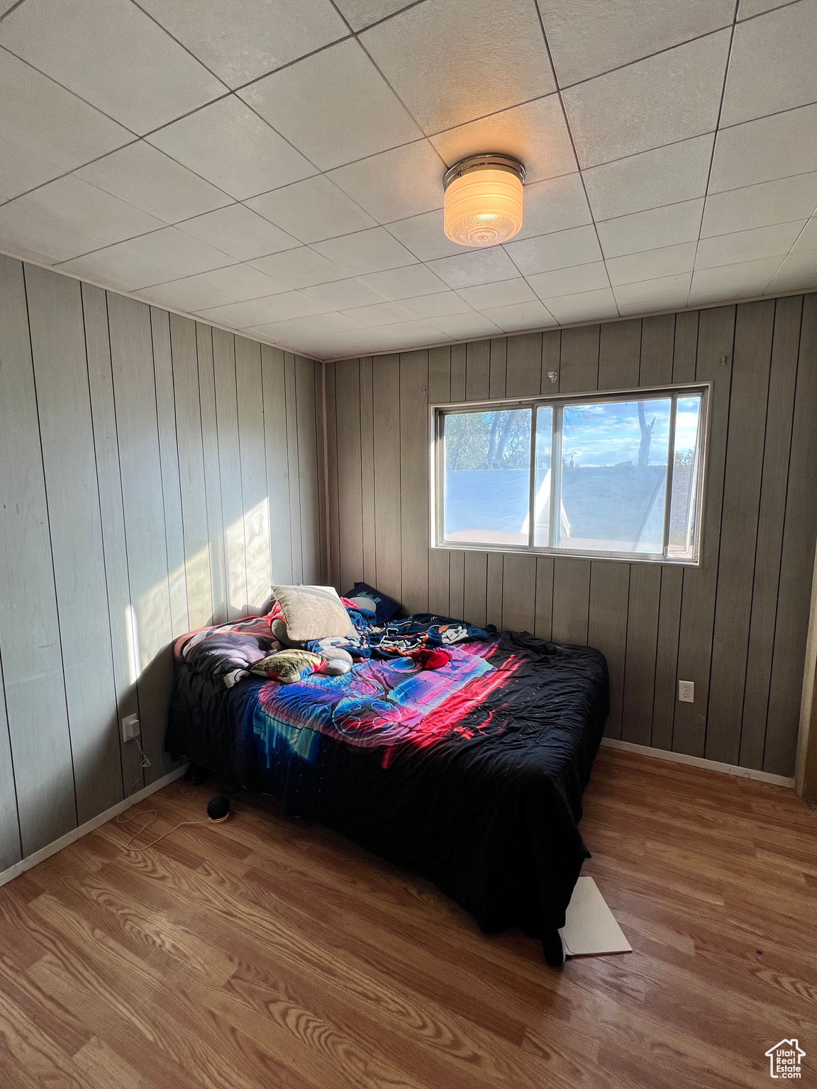 Bedroom featuring wood walls and light wood-type flooring