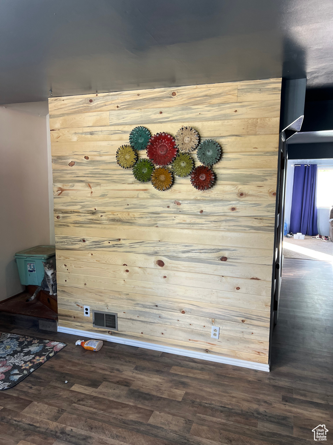 Interior details featuring wood walls and wood-type flooring