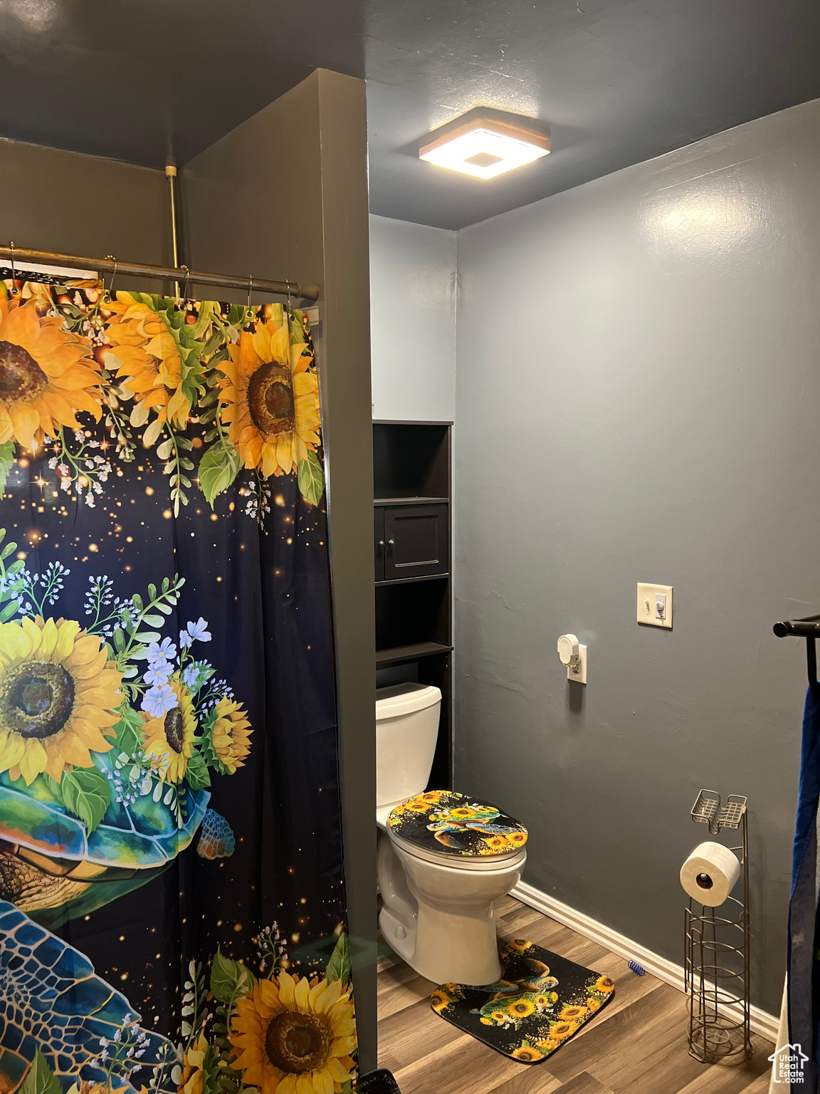 Bathroom with hardwood / wood-style floors and toilet