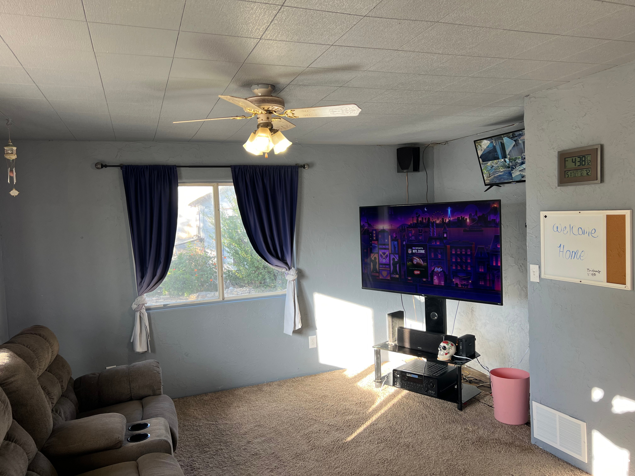 Carpeted living room featuring ceiling fan