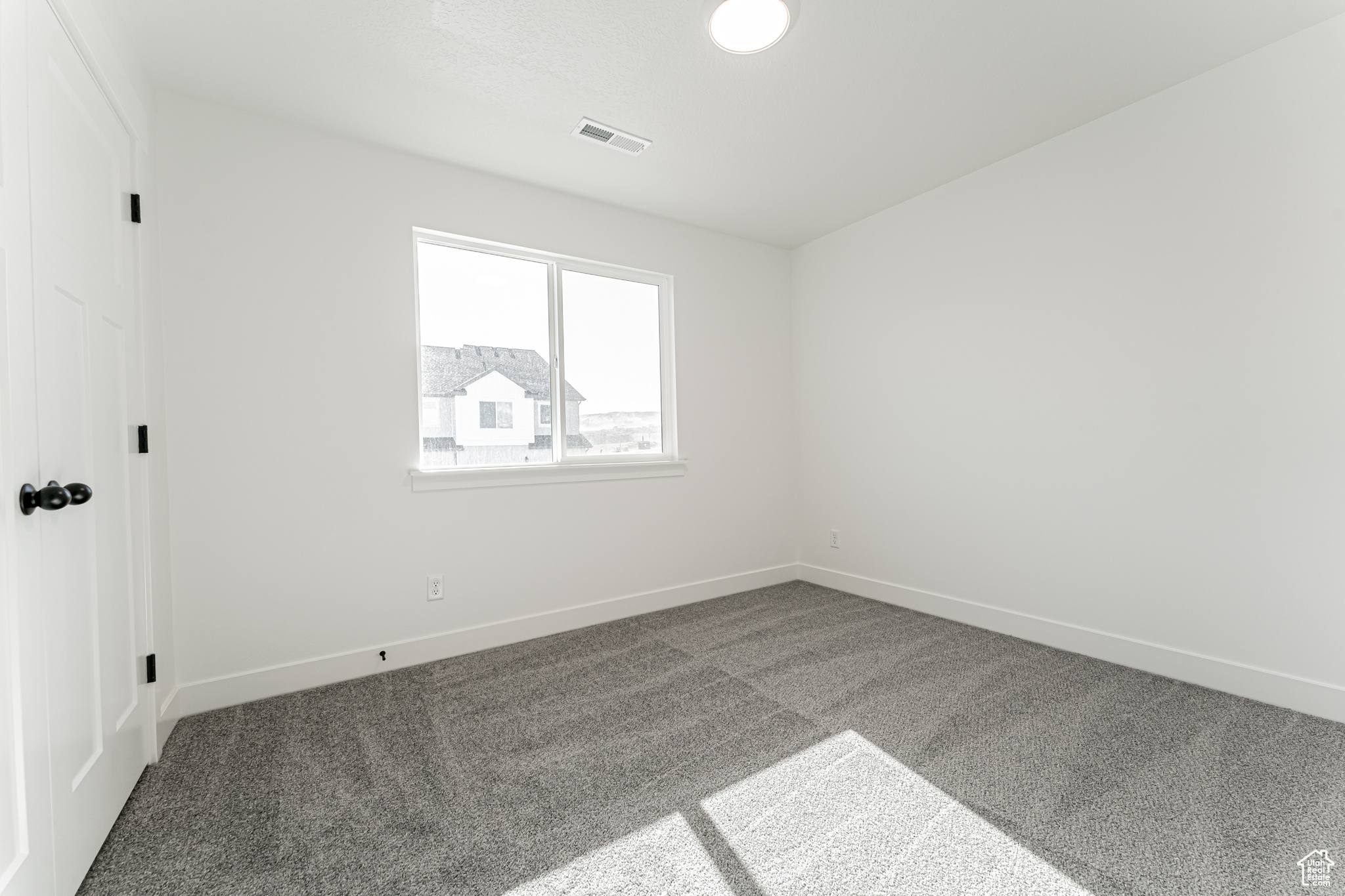 Unfurnished room with visible vents, baseboards, and carpet floors