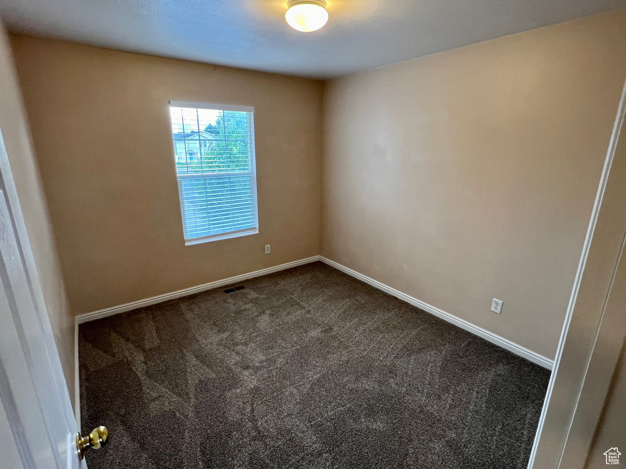 Empty room featuring carpet flooring