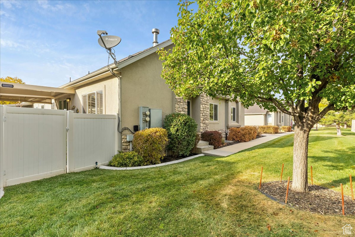 View of side of home with a yard