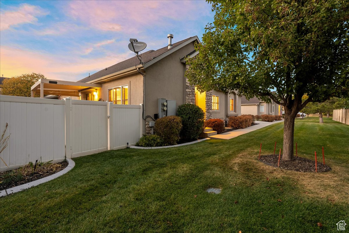 Property exterior at dusk with a lawn