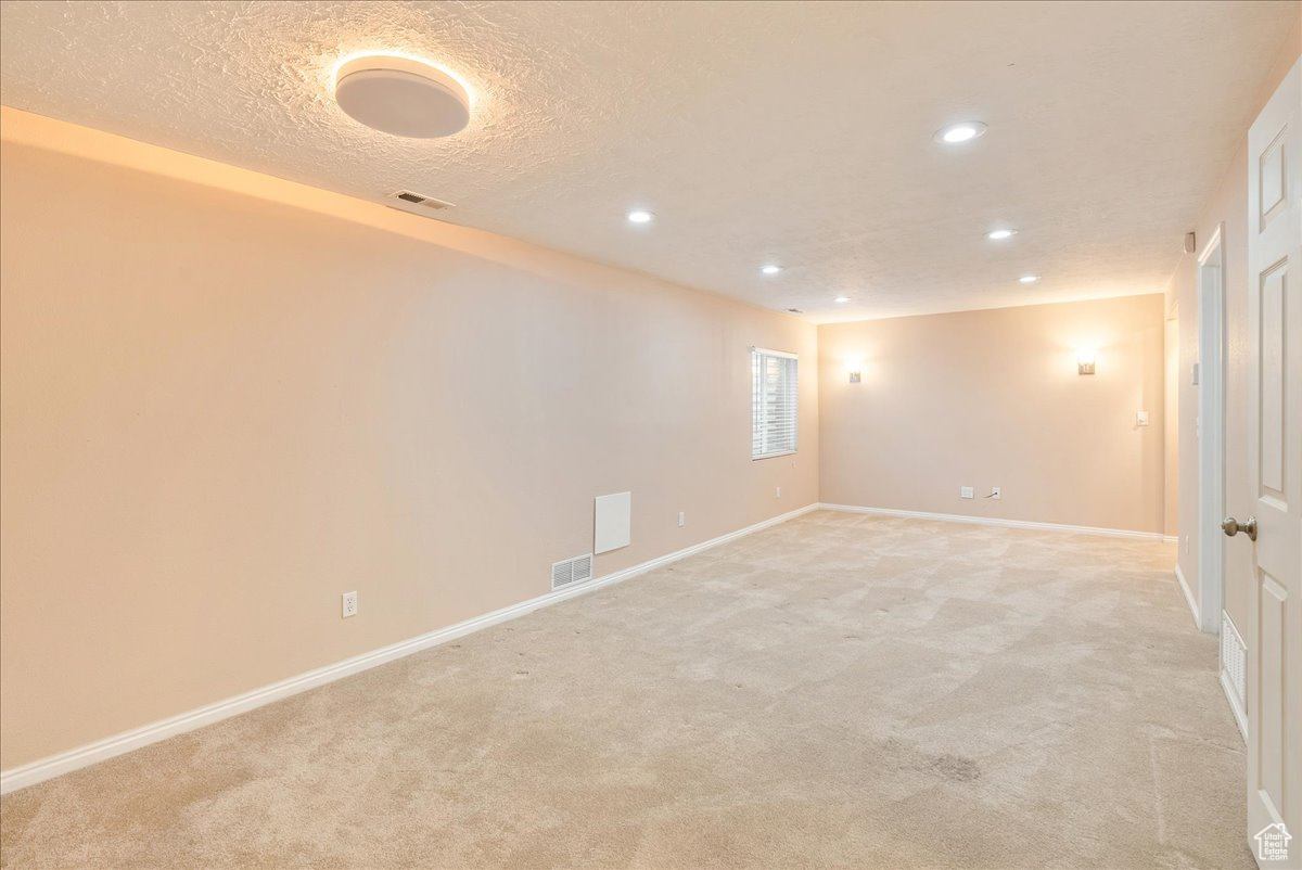 Unfurnished room featuring light colored carpet