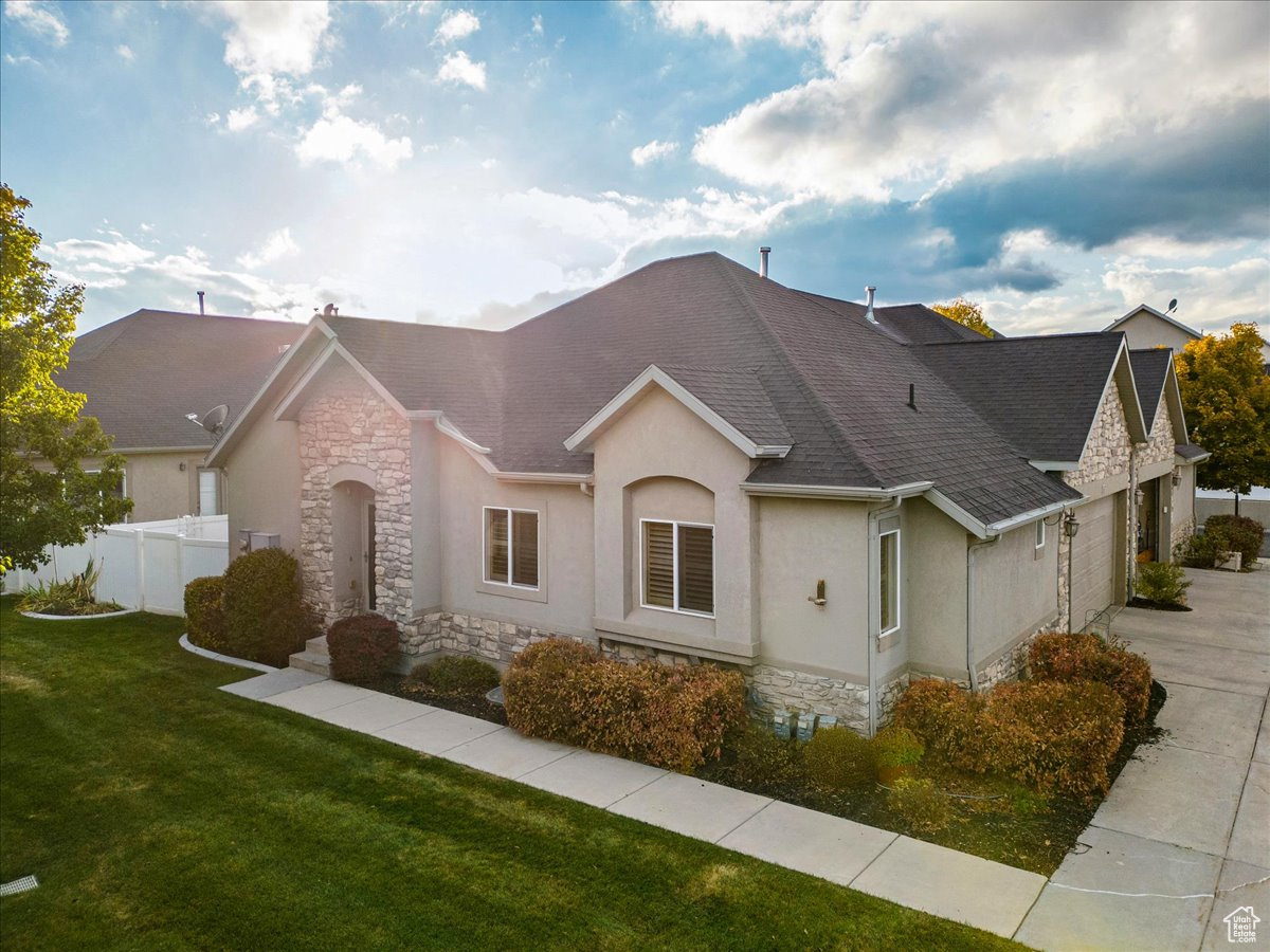 View of front of home with a front yard and a garage