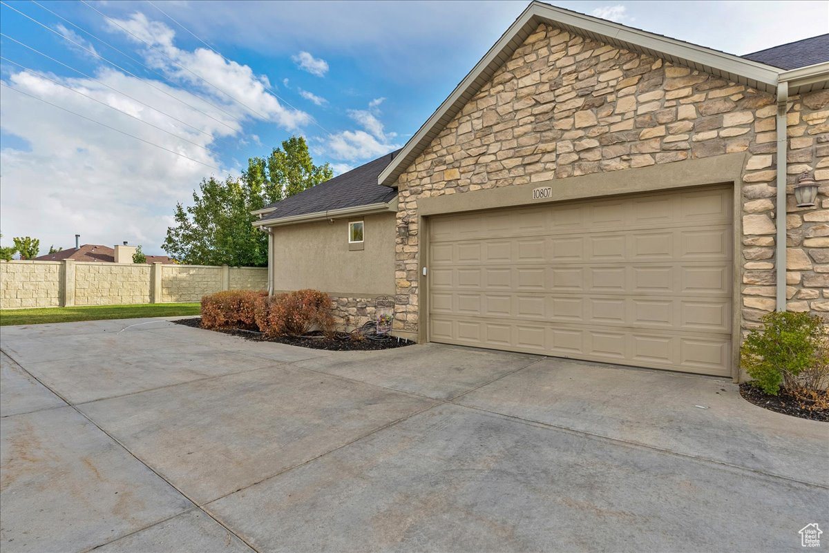 View of side of home with a garage