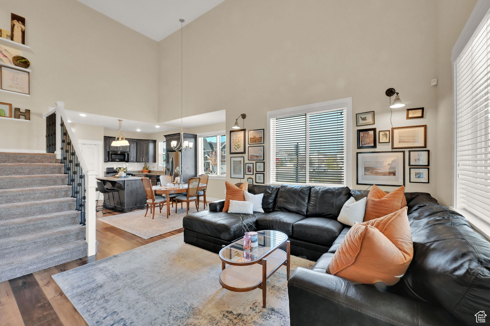 Living room featuring a towering ceiling and wood-type flooring