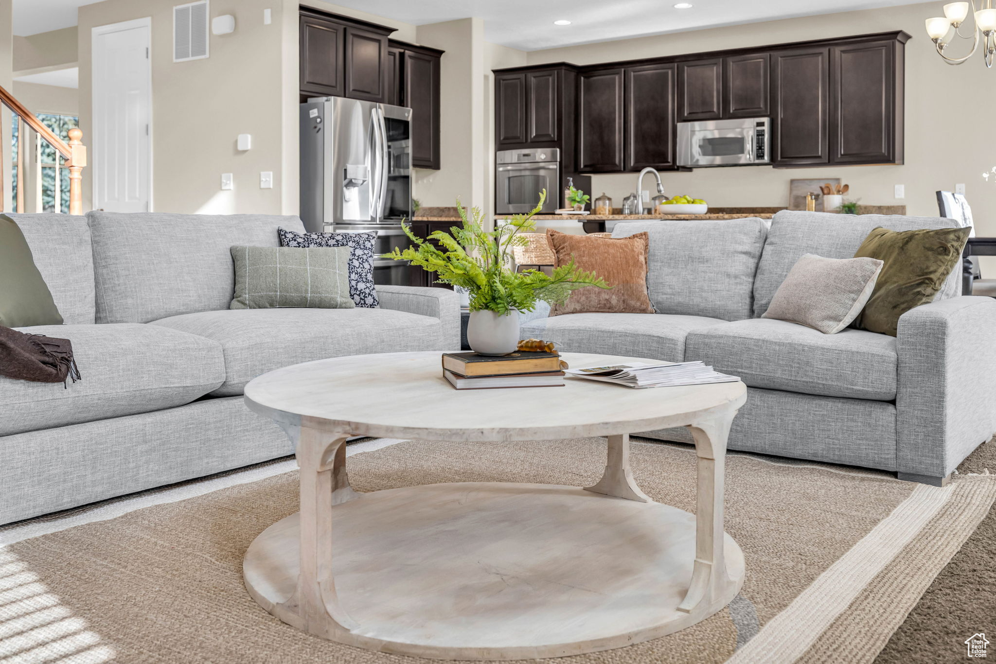 Living room featuring a notable chandelier and sink