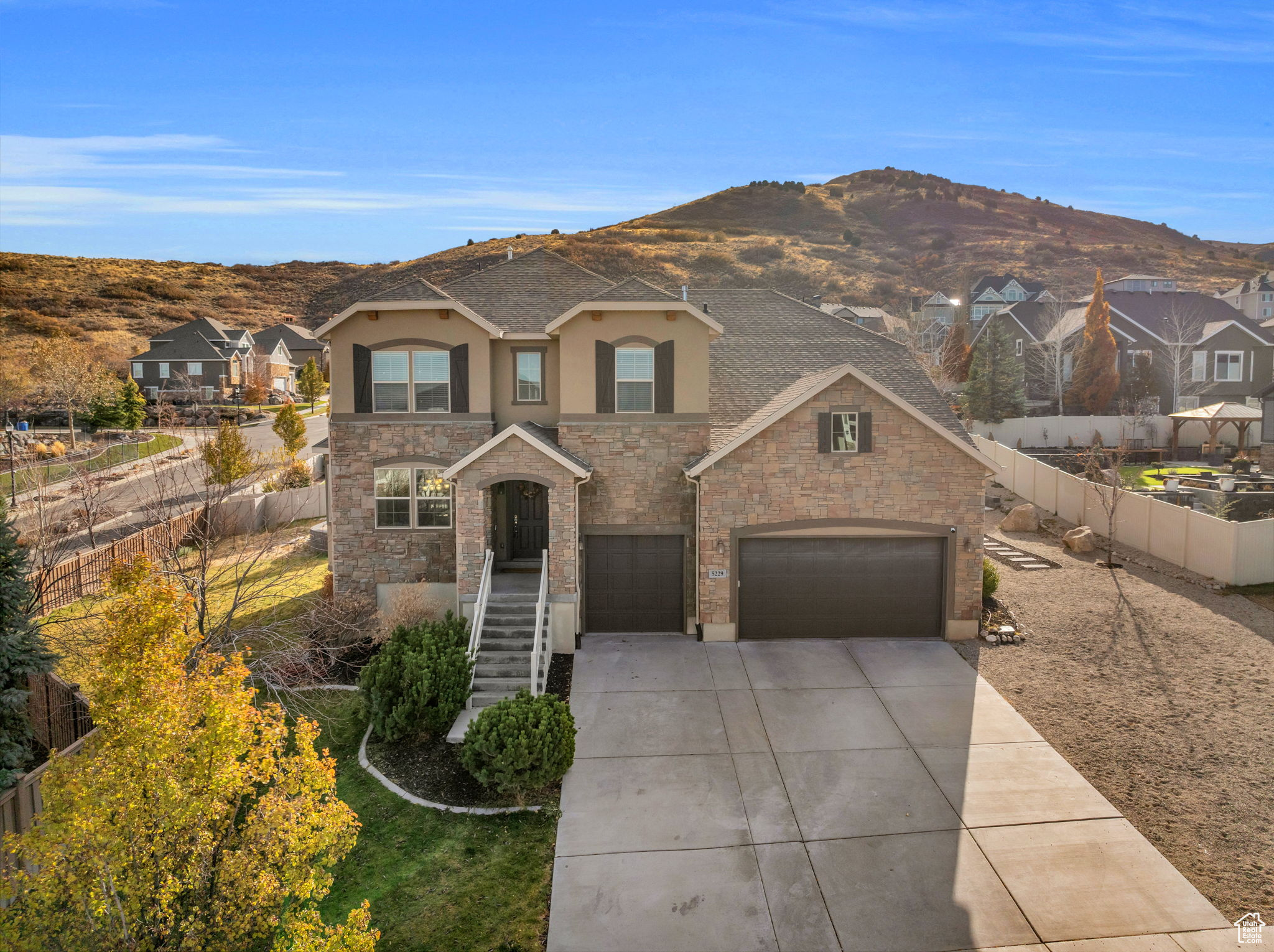 View of front of house with a mountain view and a garage