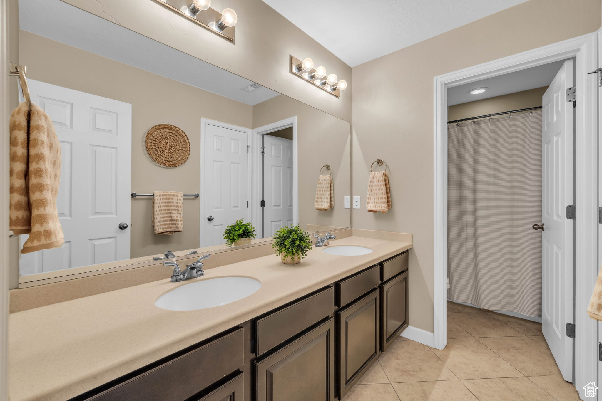 Bathroom featuring tile patterned flooring and vanity