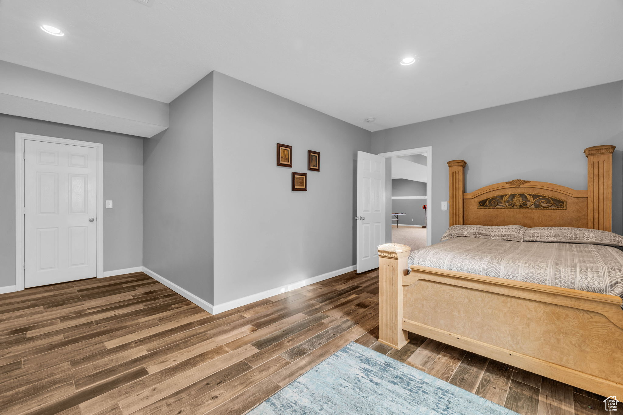 Bedroom with dark hardwood / wood-style flooring