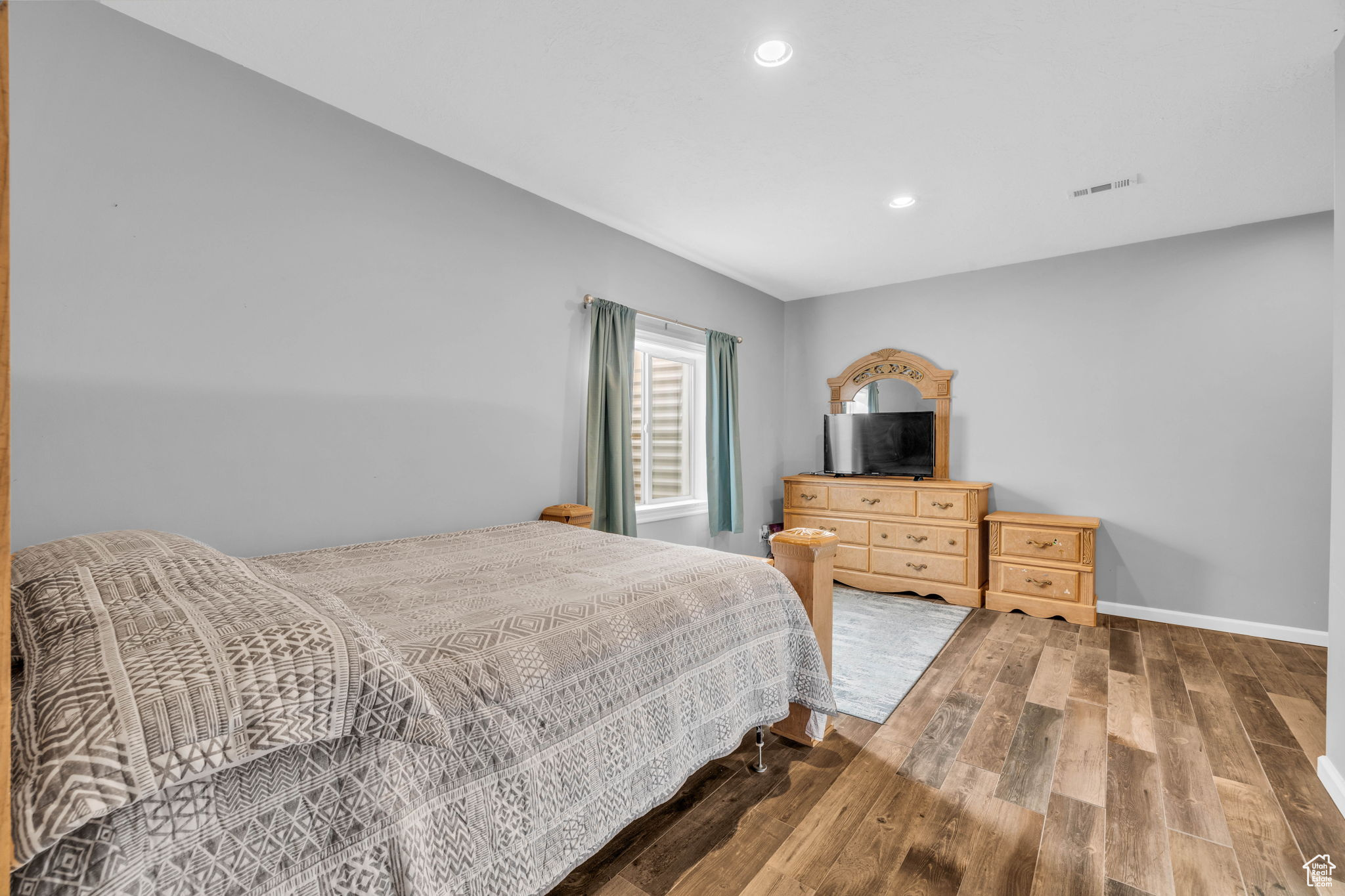 Bedroom with hardwood / wood-style flooring