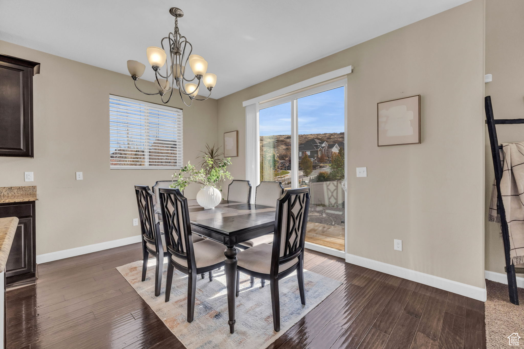 Dining area with dark hardwood / wood-style floors and a chandelier