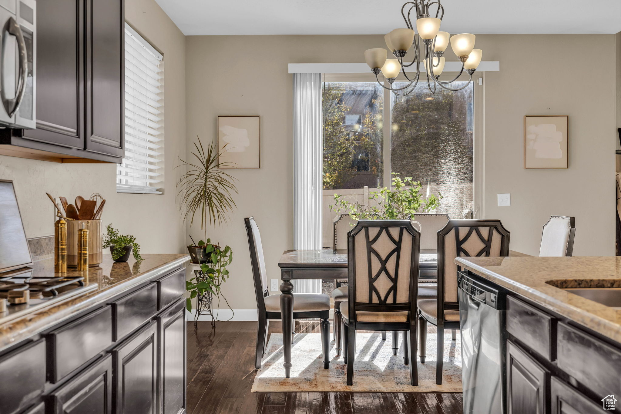 Dining room with a notable chandelier and dark hardwood / wood-style floors