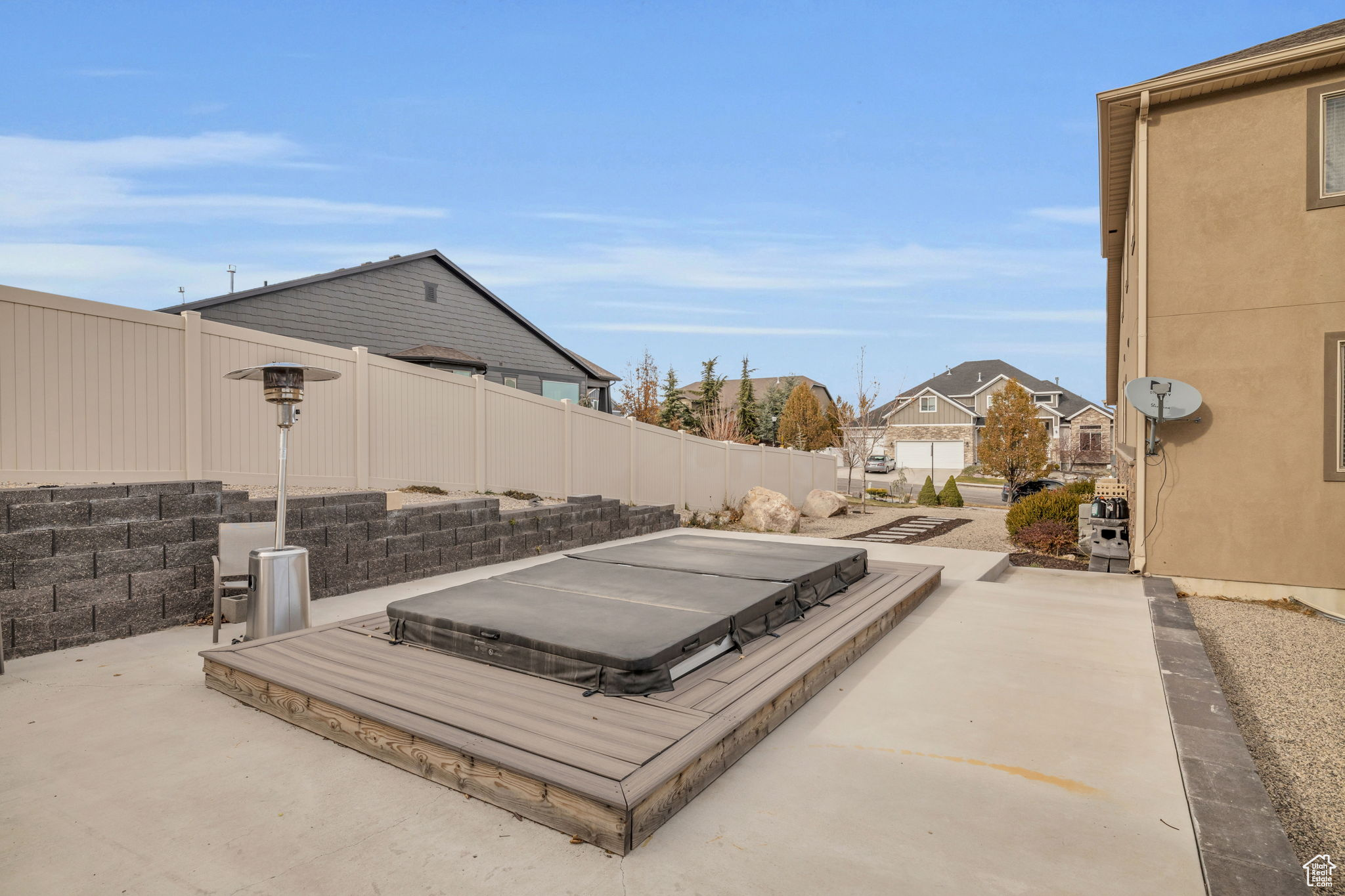 View of patio featuring a covered hot tub