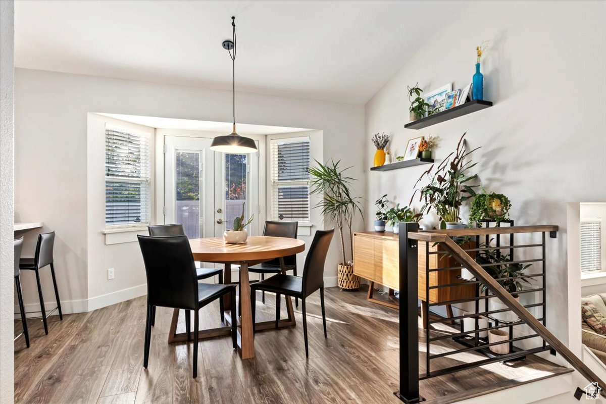 Dining area featuring hardwood / wood-style flooring and vaulted ceiling