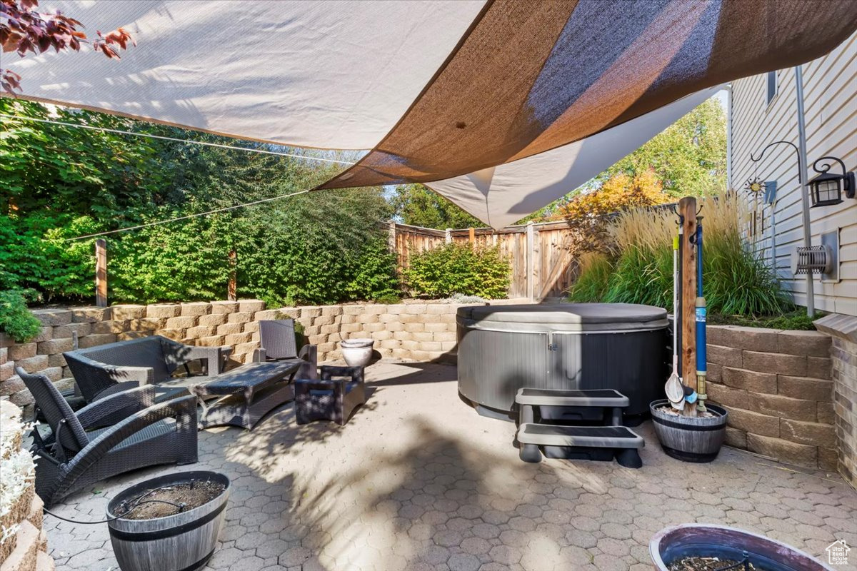 View of patio featuring a hot tub