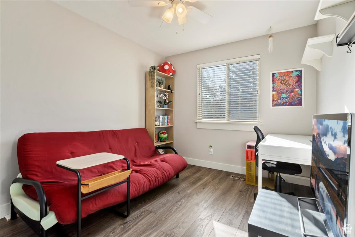 Office space with hardwood / wood-style flooring and ceiling fan