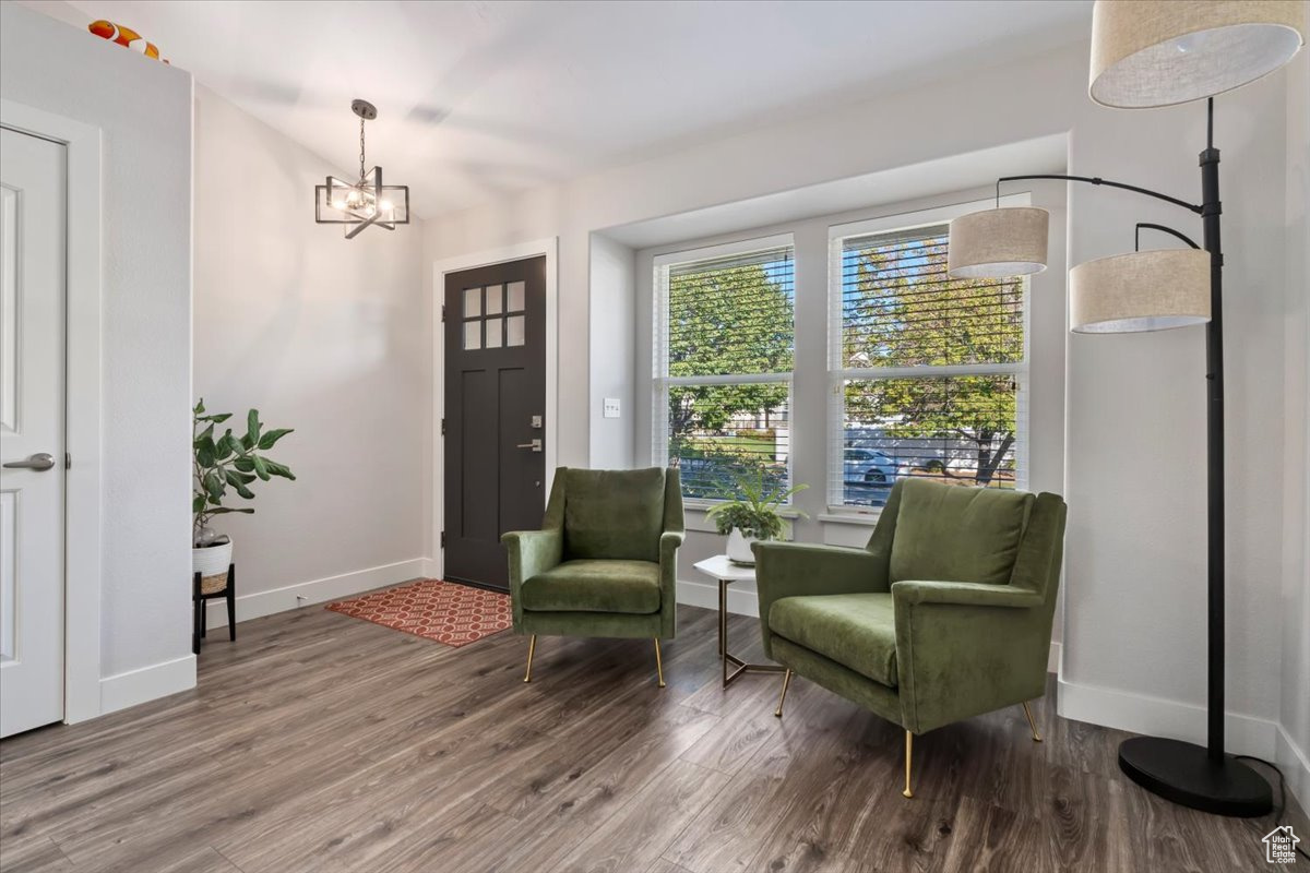 Living area featuring a chandelier and wood-type flooring