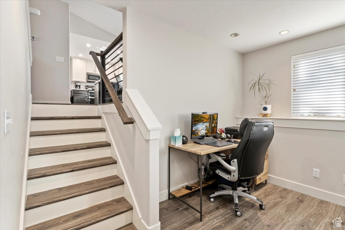 Home office with light hardwood / wood-style flooring