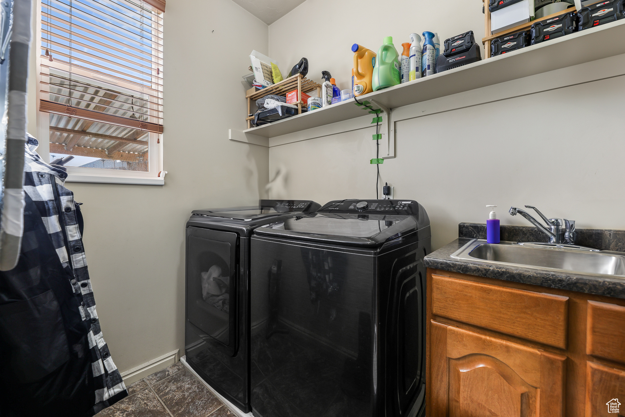 Laundry area featuring sink, a healthy amount of sunlight, and washer and clothes dryer