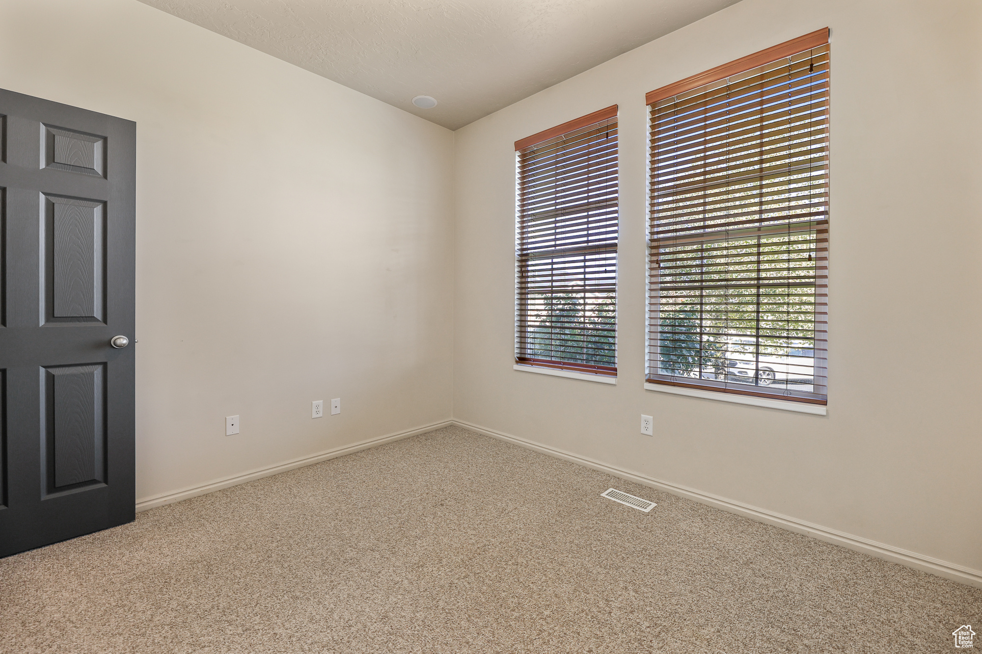 Carpeted spare room featuring a textured ceiling