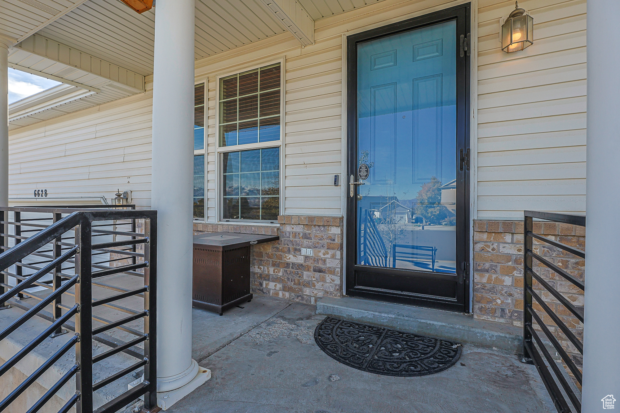 Entrance to property featuring covered porch