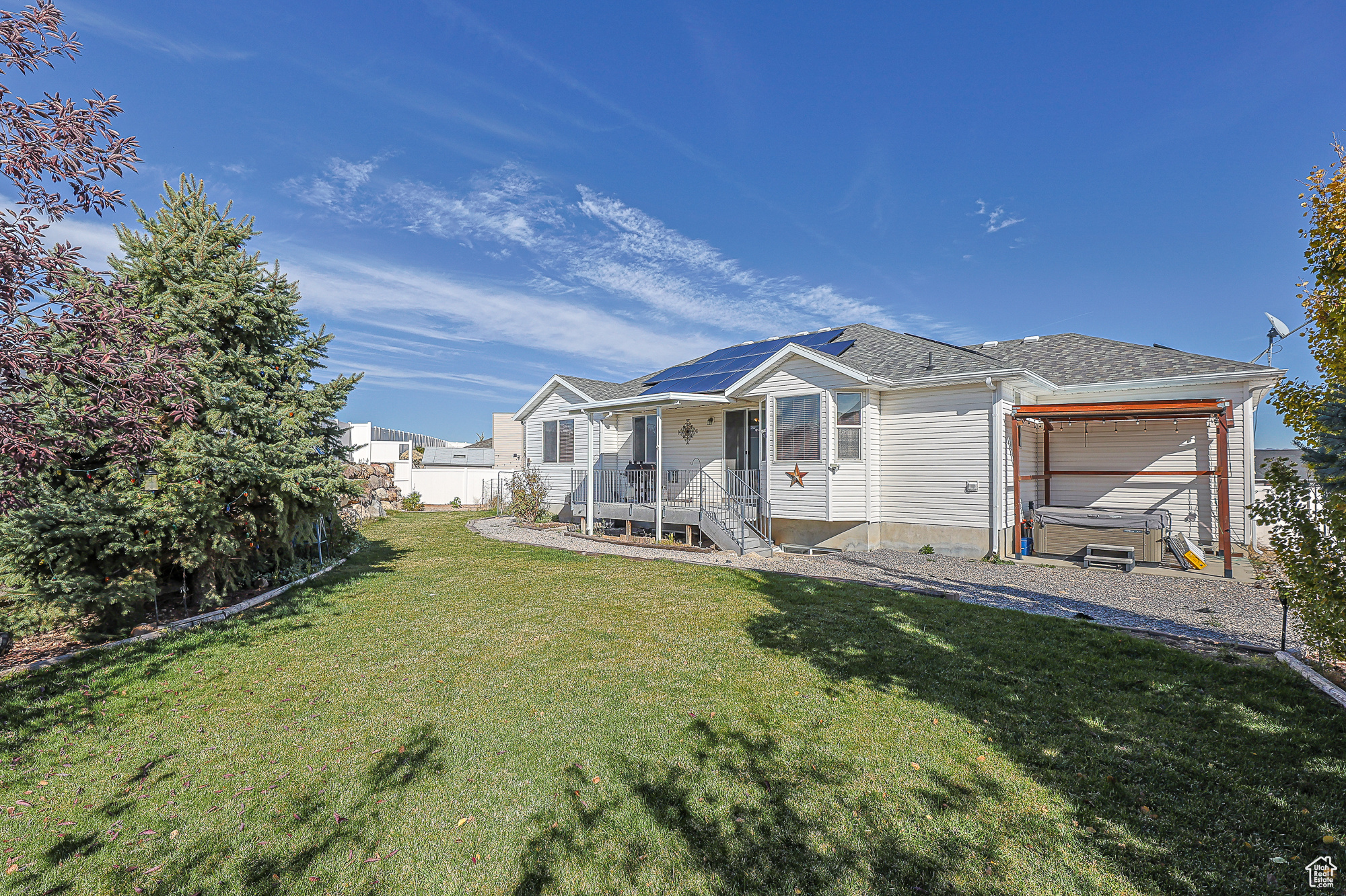 Back of property featuring a patio area and a lawn