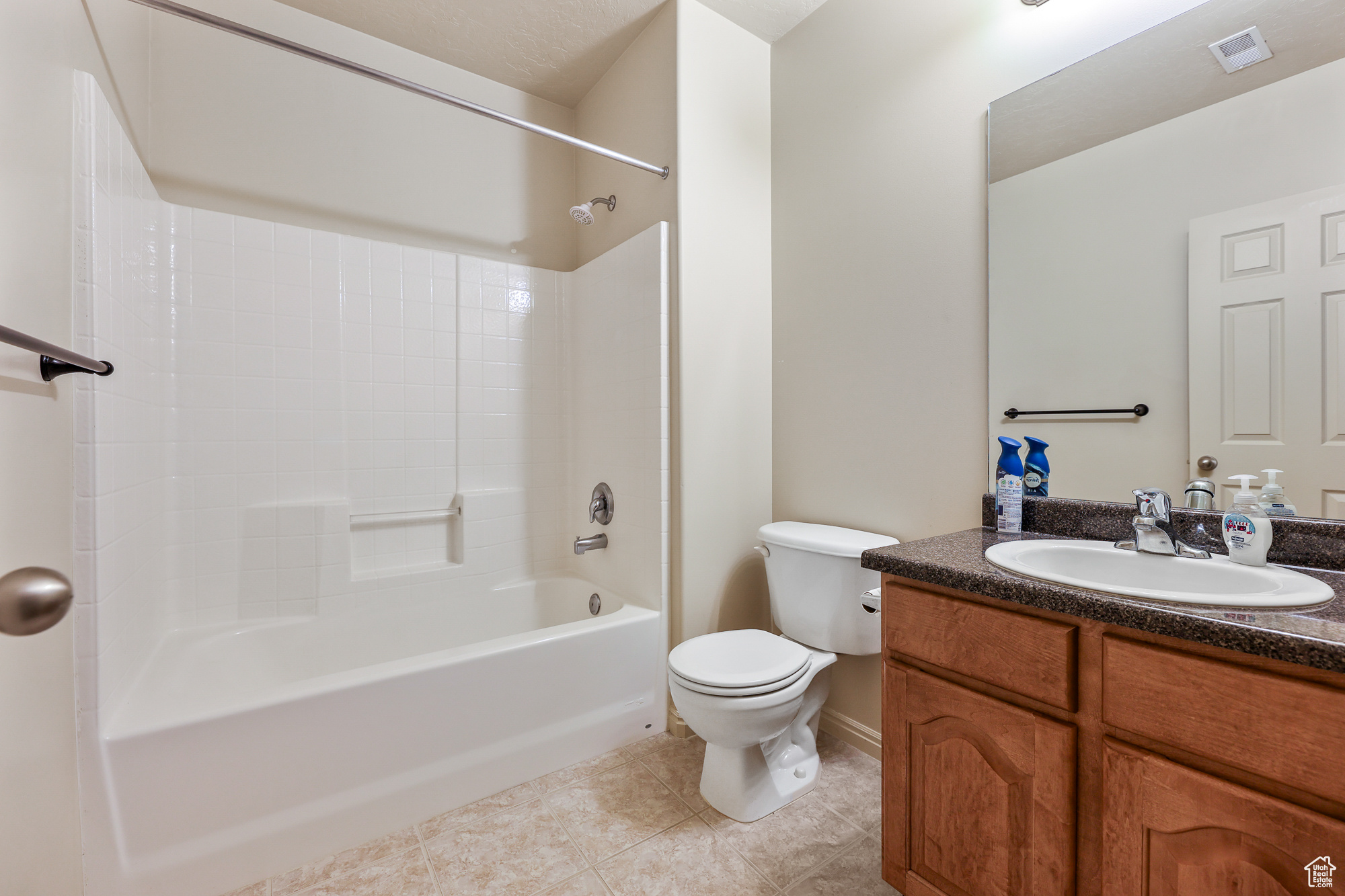 Full bathroom with  shower combination, vanity, toilet, and tile patterned floors