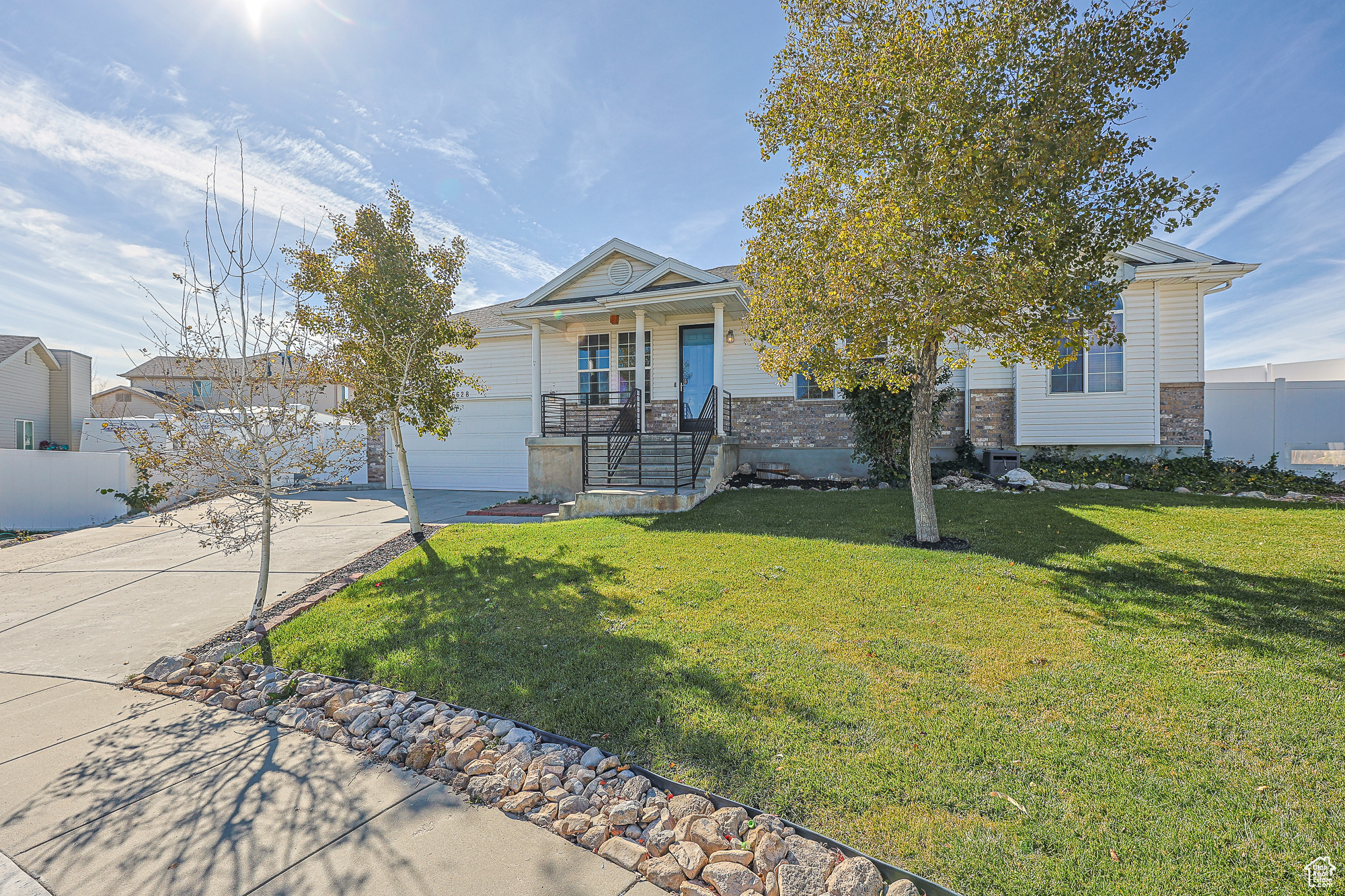 View of front of home featuring a front yard and a garage