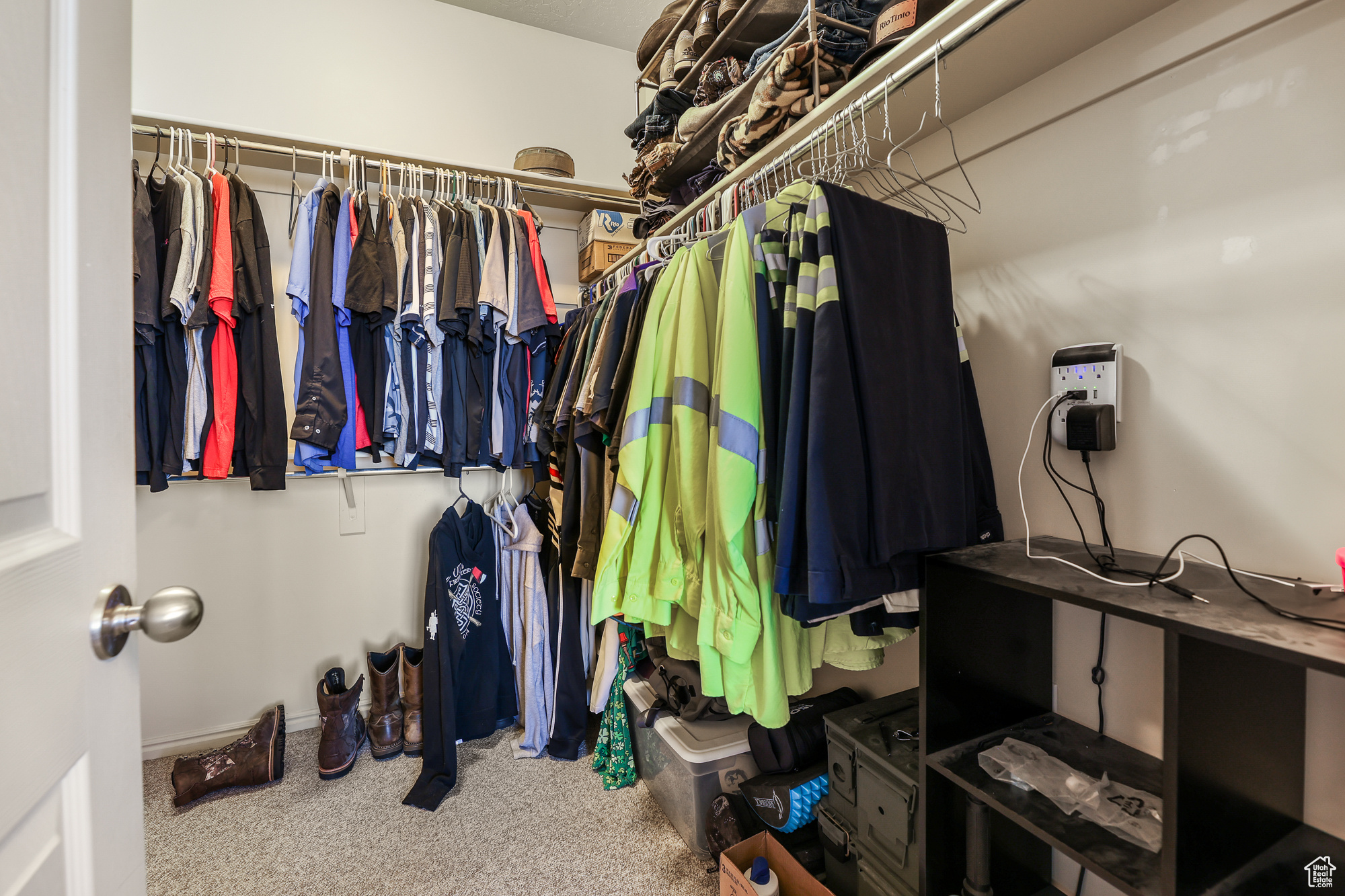 Walk in closet with carpet floors