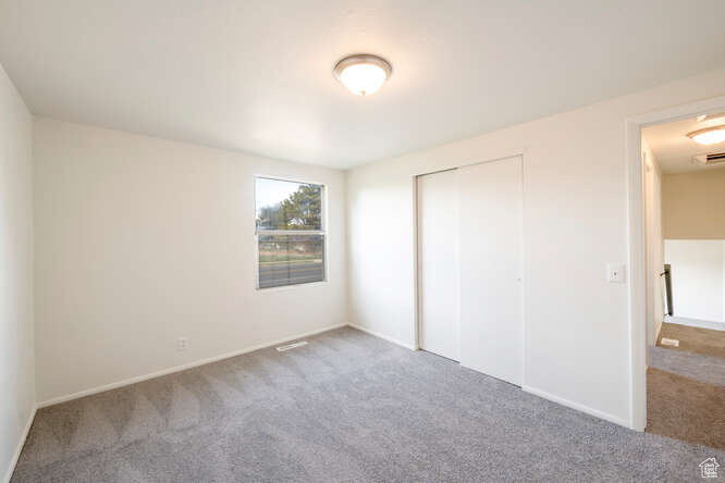 Bedroom #3 with a closet and carpet flooring