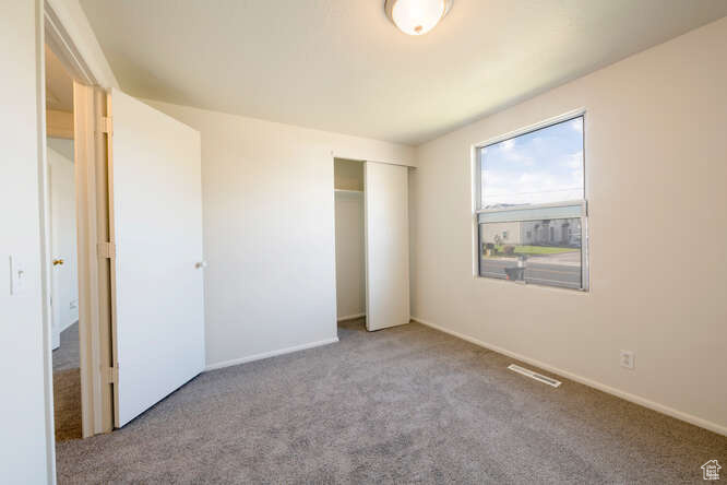 Bedroom #2 featuring light colored carpet