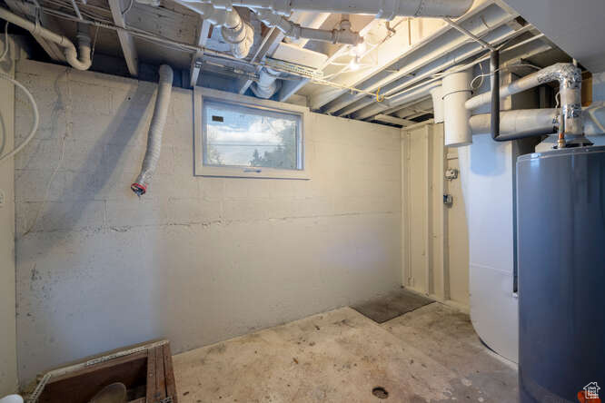 Laundry room featuring water heater, furnace