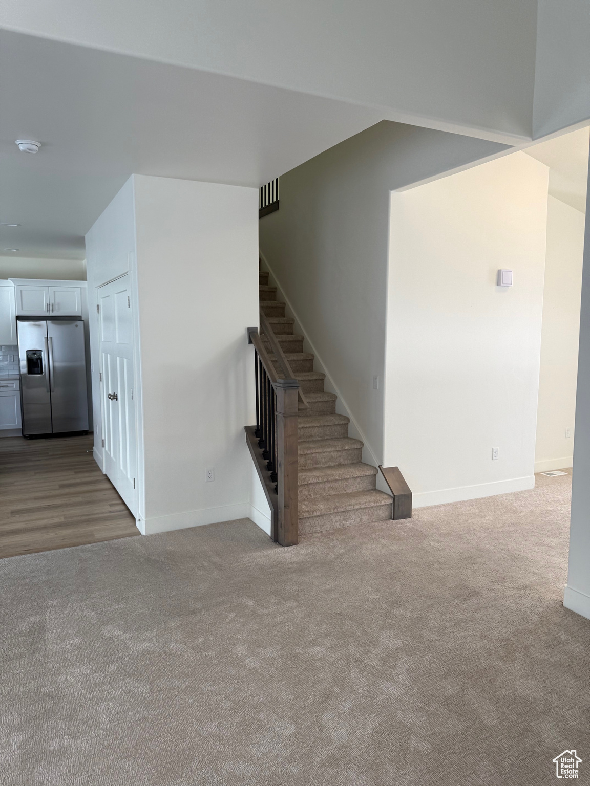 Stairway featuring carpet flooring