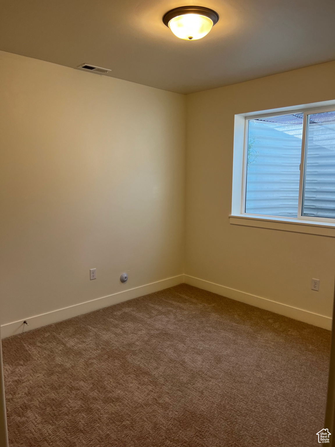 Spare room featuring carpet flooring