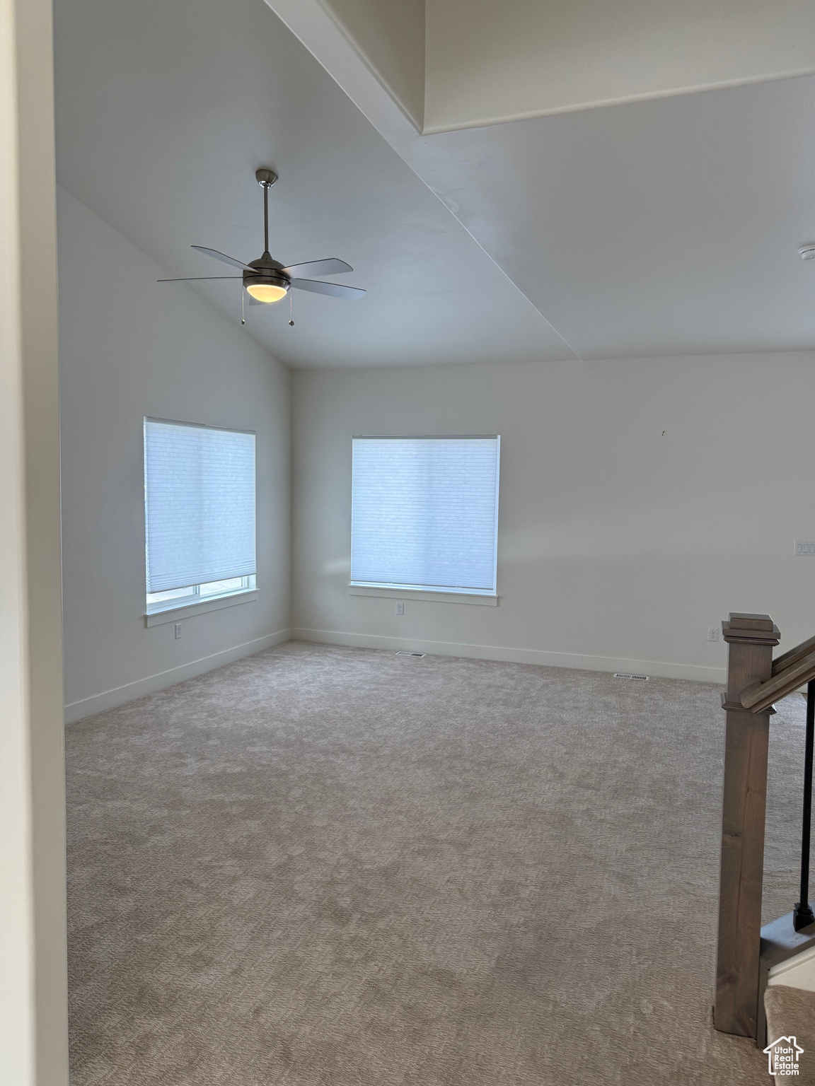 Unfurnished room with ceiling fan, lofted ceiling, and light colored carpet