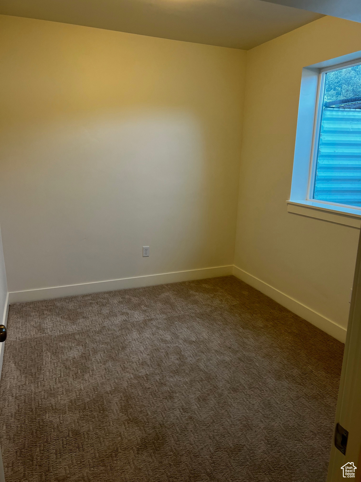 Empty room featuring dark carpet