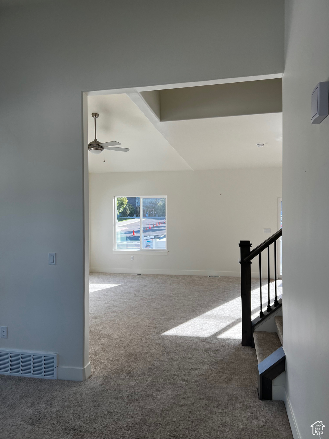 Stairs featuring carpet flooring and ceiling fan