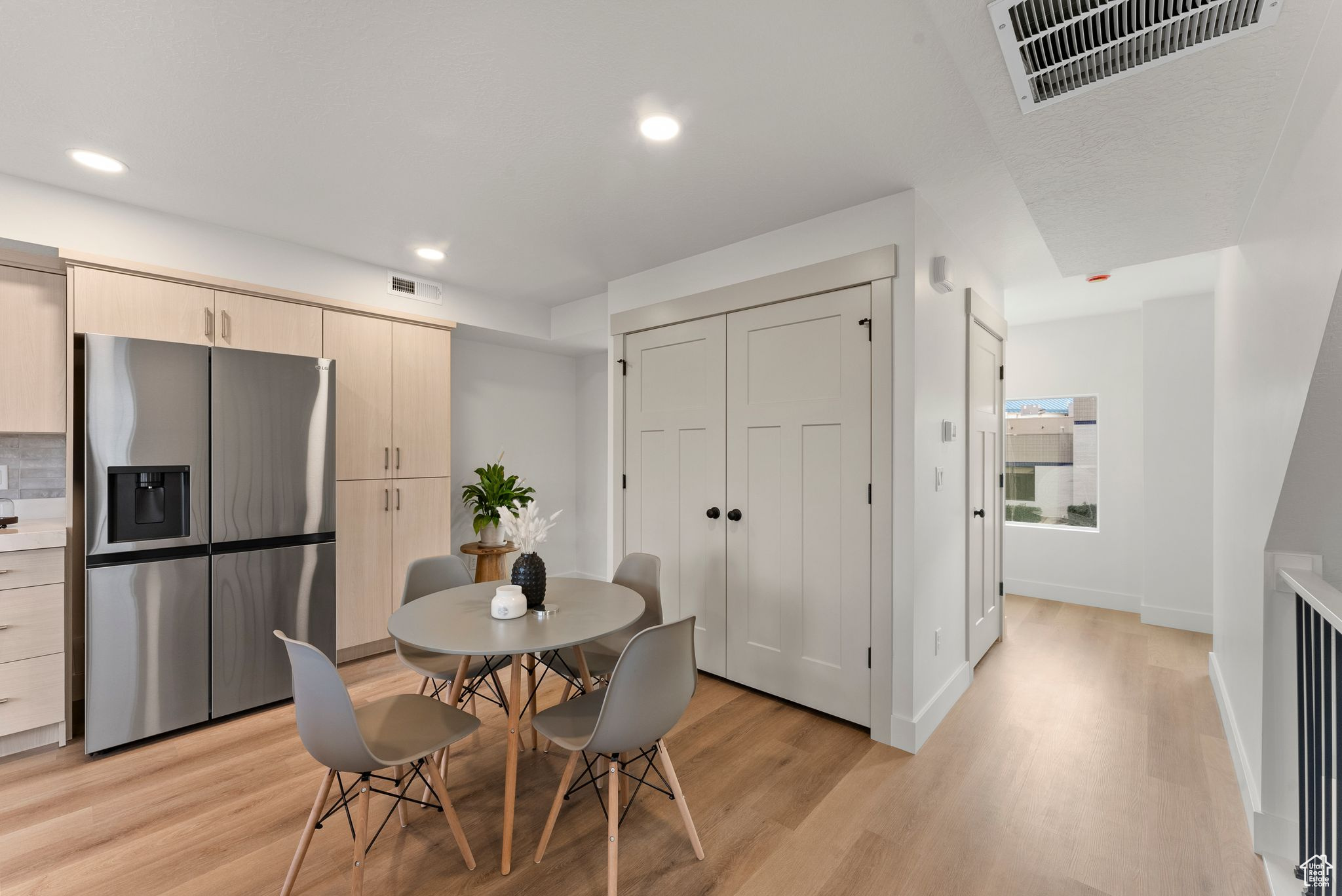 Dining area with light hardwood / wood-style floors