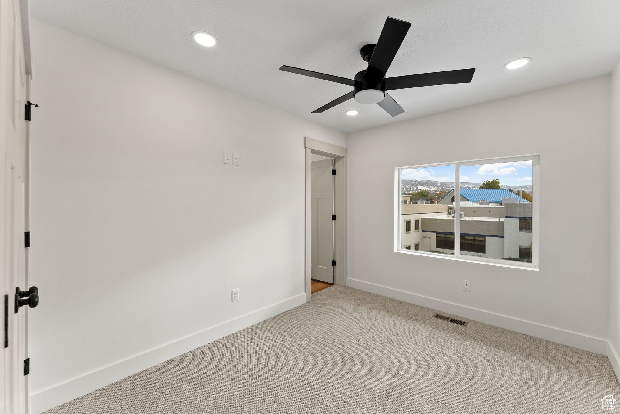 Unfurnished bedroom featuring ceiling fan and light carpet