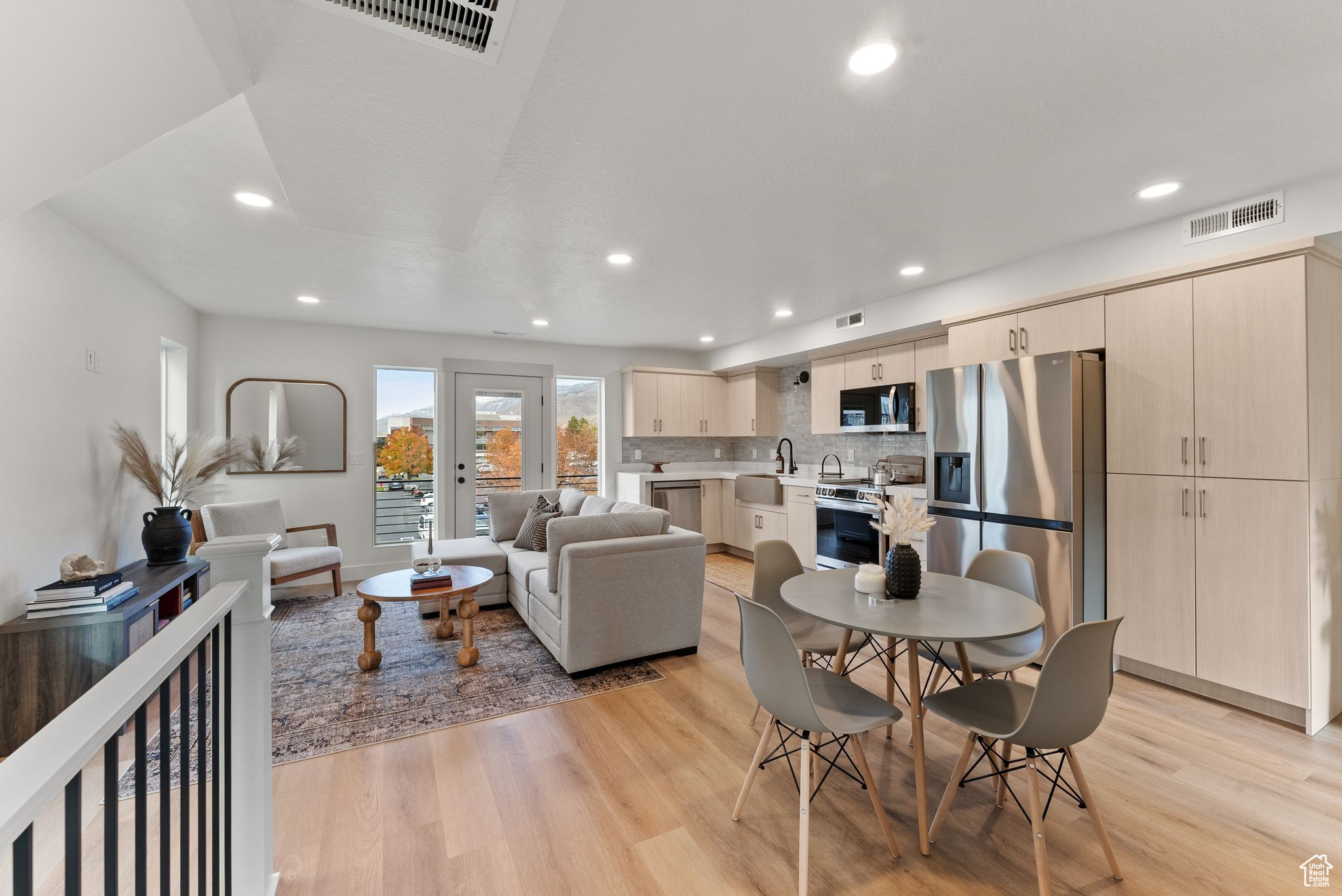 Living room with light hardwood / wood-style floors and sink