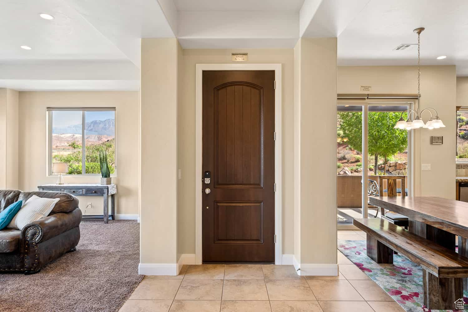 Foyer entrance featuring a notable chandelier and light tile patterned flooring