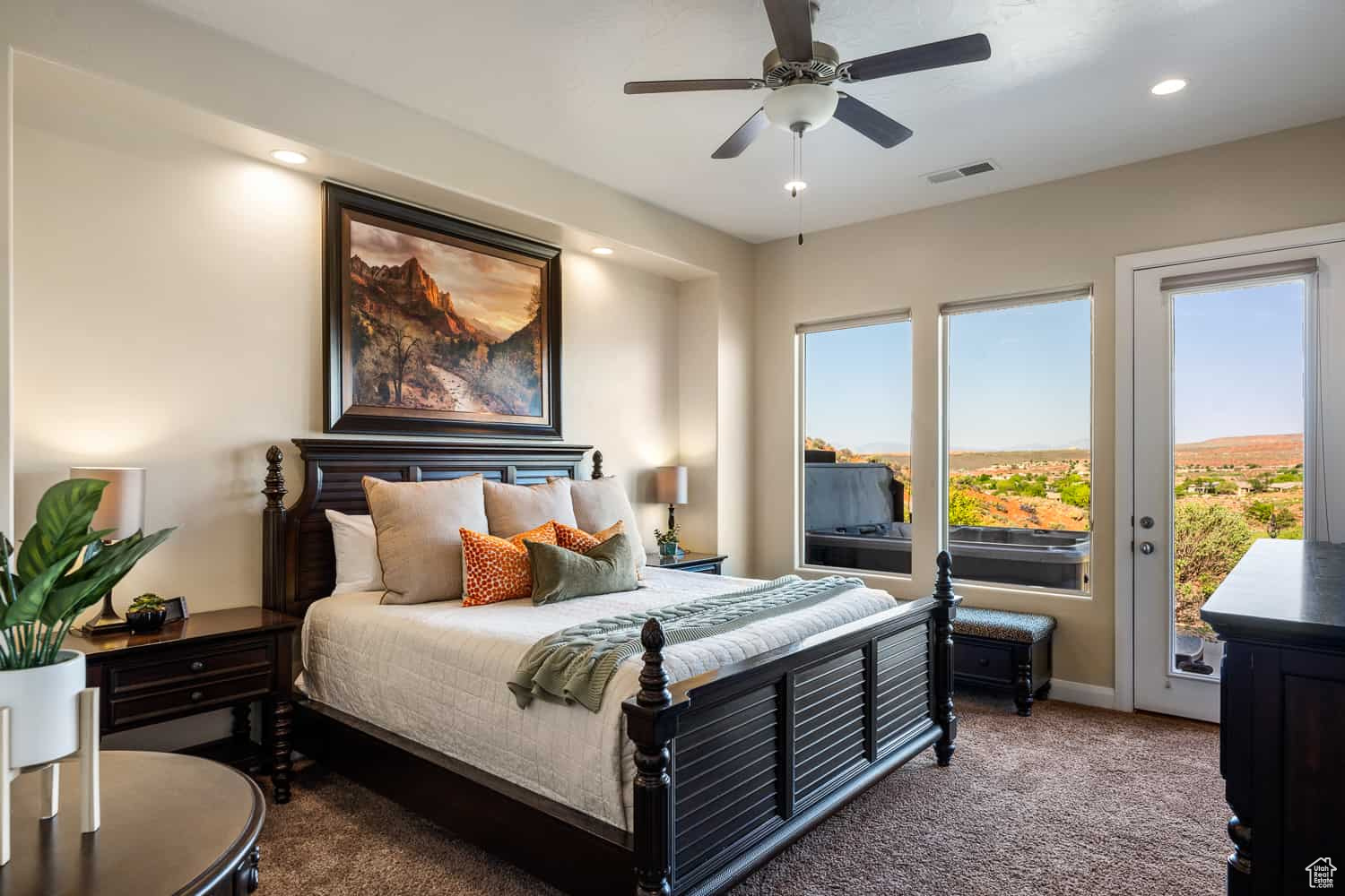 Carpeted bedroom featuring access to exterior and ceiling fan