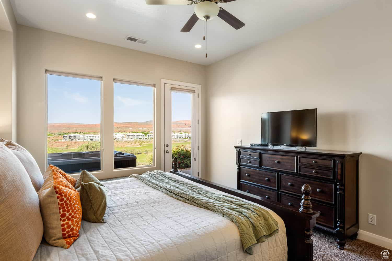 Bedroom featuring access to outside, carpet floors, and ceiling fan