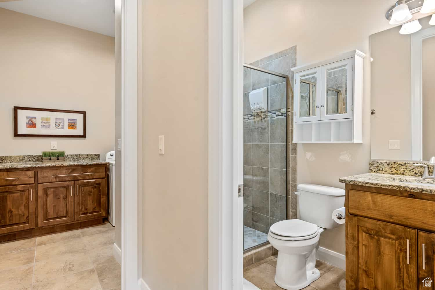 Bathroom with toilet, an enclosed shower, and vanity